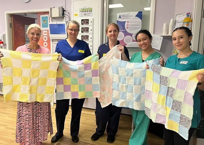 Residents at a care home in Slough have knitted more than 100 blankets to help babies, animals and homeless people stay warm.